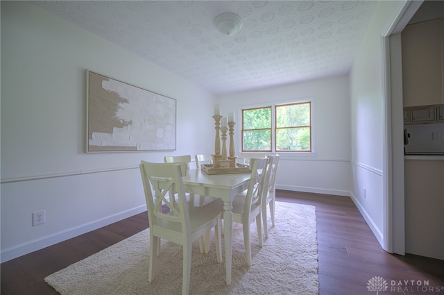 dining area featuring wood finished floors and baseboards