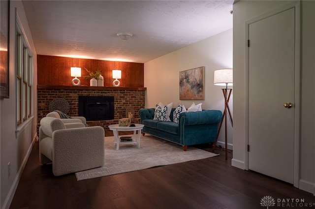 living room with a fireplace, wood finished floors, and baseboards