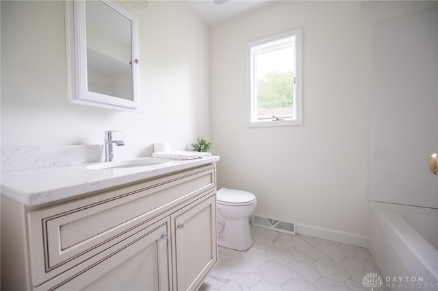 full bathroom with toilet, vanity, baseboards, a tub to relax in, and tile patterned flooring