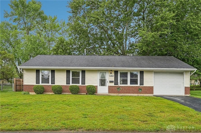 ranch-style home with brick siding, asphalt driveway, and an attached garage