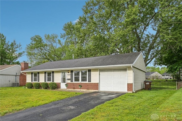 ranch-style home with brick siding, an attached garage, driveway, and central AC