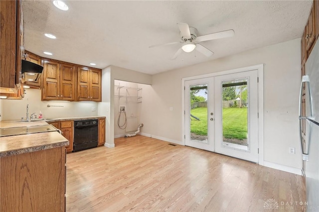 kitchen with dishwasher, a sink, ceiling fan, light wood-style flooring, and baseboards