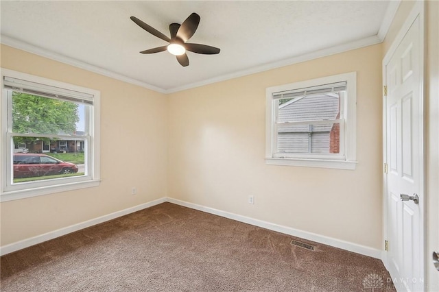 carpeted spare room featuring baseboards, a ceiling fan, and crown molding