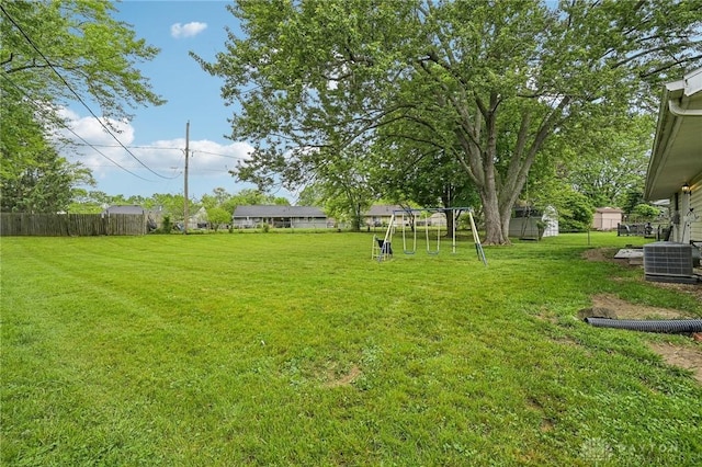 view of yard with a playground and central AC