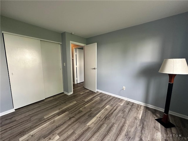 5700 Coach Dr Unit B, Kettering, OH 45440 - unfurnished bedroom featuring wood finished floors, baseboards, and a closet