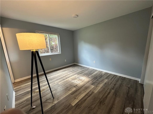 5700 Coach Dr Unit B, Kettering, OH 45440 - spare room featuring dark wood-style floors, baseboards, and a smoke detector