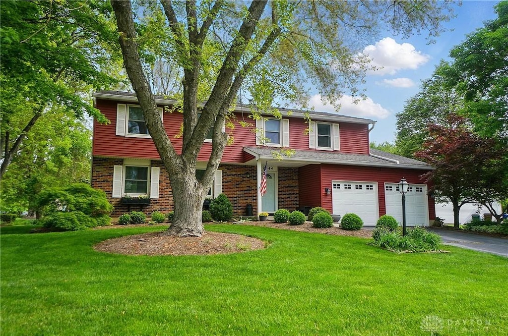 2544 Kewanna Ln, Beavercreek, OH 45434 - view of front of property featuring asphalt driveway, a front lawn, and brick siding