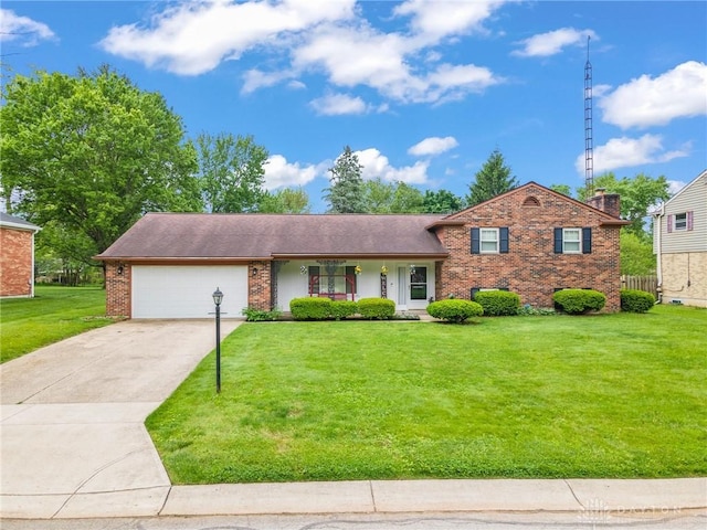 4160 Cedar Bluff Cir, Dayton, OH 45415 - split level home featuring an attached garage, brick siding, driveway, a front yard, and covered porch