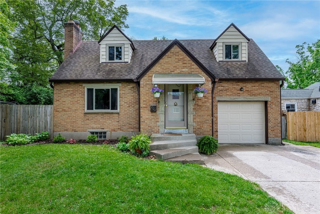 704 Oakview Dr, Kettering, OH 45429 - view of front of property with brick siding, concrete driveway, a chimney, and a garage