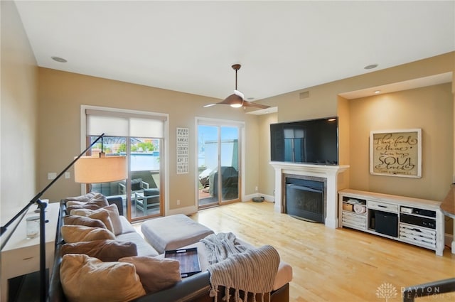 2731 Cleinview Ave Unit 2, Cincinnati, OH 45206 - living area featuring a glass covered fireplace, light wood-style floors, and a ceiling fan