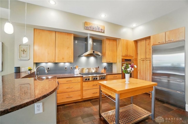 2731 Cleinview Ave Unit 2, Cincinnati, OH 45206 - kitchen with wall chimney exhaust hood, stainless steel appliances, dark stone finish floors, light brown cabinets, and a peninsula
