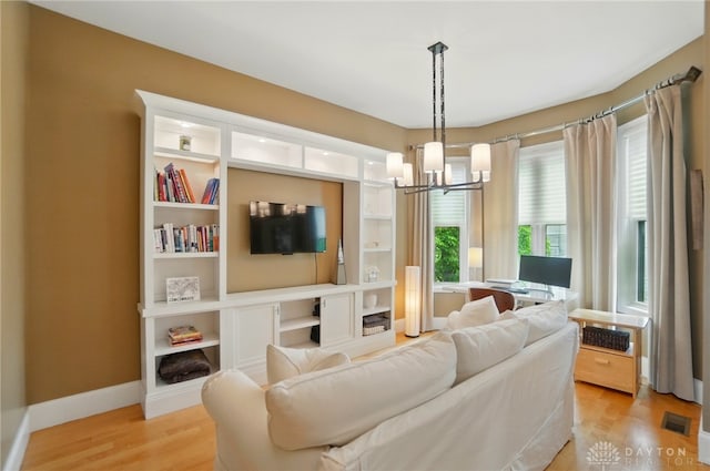 2731 Cleinview Ave Unit 2, Cincinnati, OH 45206 - living room featuring a chandelier, light wood finished floors, and baseboards