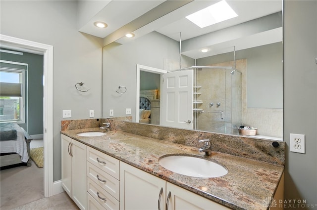 2731 Cleinview Ave Unit 2, Cincinnati, OH 45206 - ensuite bathroom featuring a shower stall, double vanity, a skylight, and baseboards
