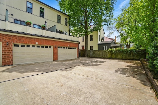 2731 Cleinview Ave Unit 2, Cincinnati, OH 45206 - rear view of property with concrete driveway, brick siding, and fence