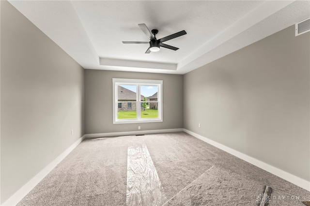 755 W Bentley Cir, Troy, OH 45373 - empty room with a ceiling fan, carpet flooring, a raised ceiling, and baseboards