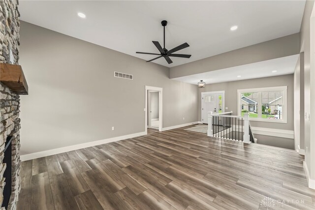755 W Bentley Cir, Troy, OH 45373 - unfurnished living room featuring a ceiling fan, wood finished floors, a stone fireplace, baseboards, and recessed lighting