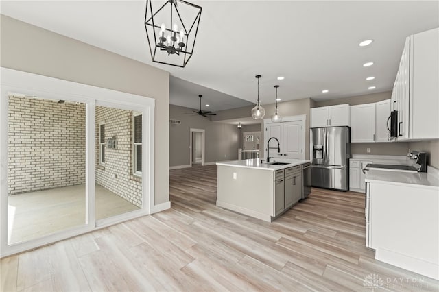 755 W Bentley Cir, Troy, OH 45373 - kitchen with appliances with stainless steel finishes, ceiling fan, an island with sink, light countertops, and recessed lighting