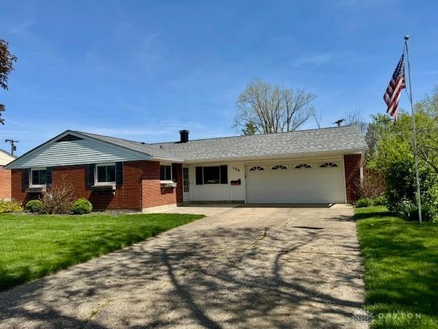 506 Lambert Ln, Englewood, OH 45322 - ranch-style house featuring a garage, driveway, brick siding, and a front yard