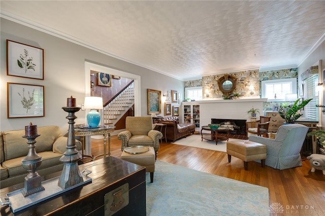 65 N Central Ave, Fairborn, OH 45324 - living room featuring wood finished floors, stairway, crown molding, a fireplace, and a textured ceiling