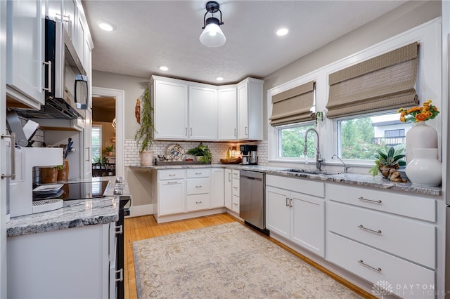 65 N Central Ave, Fairborn, OH 45324 - kitchen with appliances with stainless steel finishes, white cabinetry, tasteful backsplash, light stone countertops, and light wood finished floors