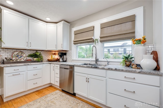 65 N Central Ave, Fairborn, OH 45324 - kitchen featuring tasteful backsplash, light wood-style flooring, stainless steel dishwasher, white cabinetry, and light stone countertops