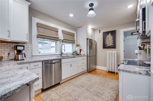 65 N Central Ave, Fairborn, OH 45324 - kitchen featuring stainless steel appliances, radiator heating unit, white cabinets, and recessed lighting