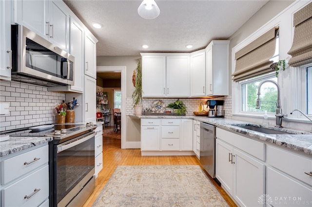 65 N Central Ave, Fairborn, OH 45324 - kitchen with stainless steel appliances, light wood-style floors, healthy amount of natural light, white cabinetry, and recessed lighting