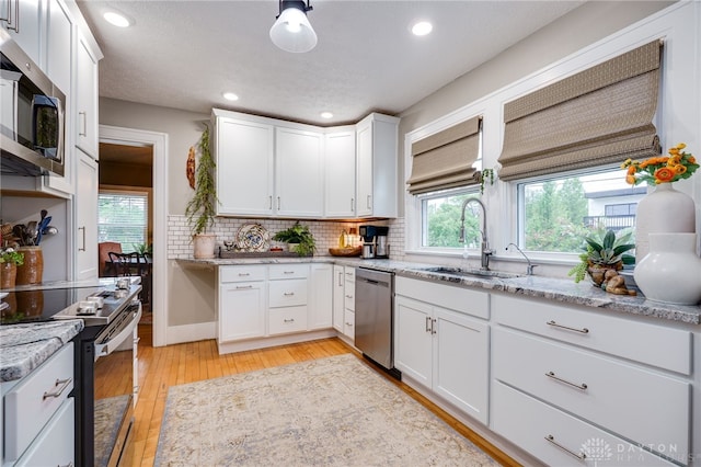 65 N Central Ave, Fairborn, OH 45324 - kitchen featuring stainless steel appliances, light wood-type flooring, white cabinetry, light stone countertops, and recessed lighting
