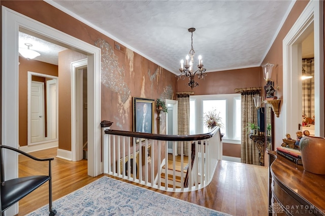 65 N Central Ave, Fairborn, OH 45324 - hall featuring an upstairs landing, wood finished floors, a chandelier, crown molding, and a textured ceiling