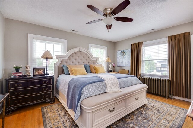 65 N Central Ave, Fairborn, OH 45324 - bedroom featuring radiator, light wood-type flooring, a ceiling fan, and a textured ceiling