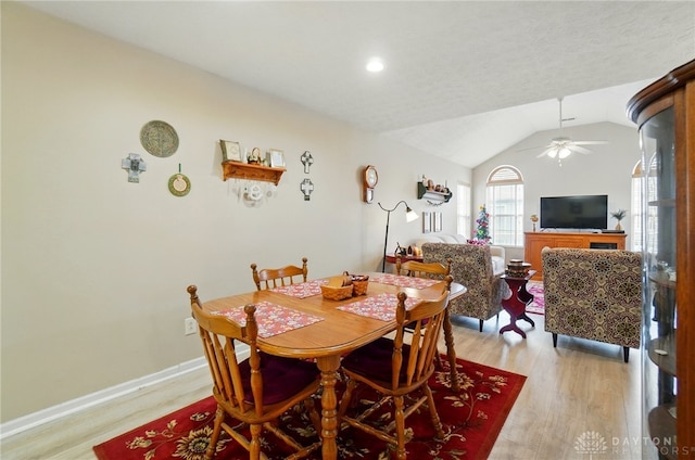 dining room featuring light wood-style floors, a ceiling fan, lofted ceiling, baseboards, and recessed lighting