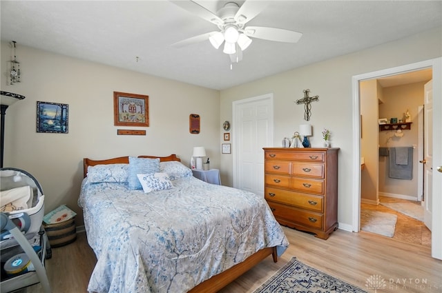 bedroom with light wood finished floors, ceiling fan, and baseboards