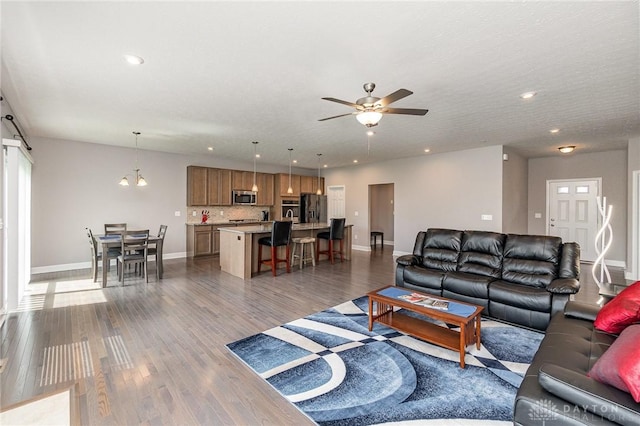 3631 Capitol Ave, Mason, OH 45040 - living area with baseboards, dark wood finished floors, a ceiling fan, recessed lighting, and a barn door