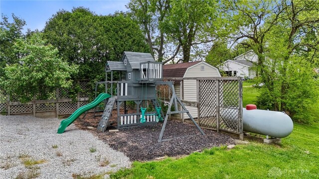 1795 Needmore Rd, Xenia, OH 45385 - view of play area featuring a storage shed, view of wooded area, and an outdoor structure
