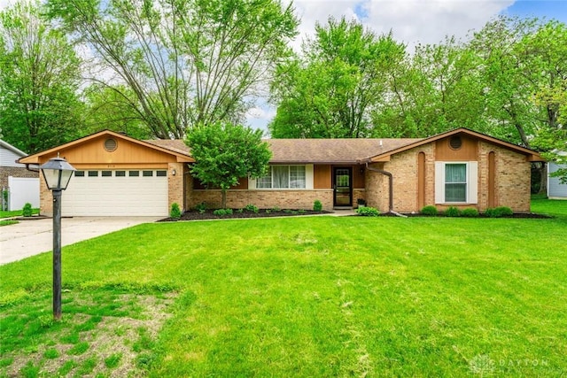 single story home with a garage, driveway, brick siding, and a front lawn
