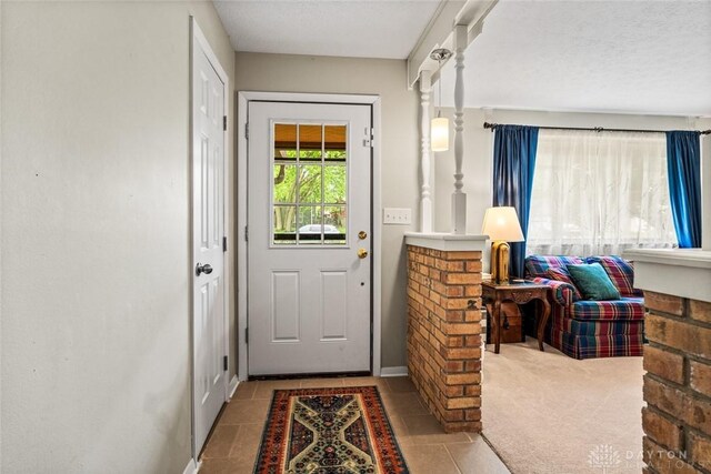 entryway with tile patterned flooring and baseboards