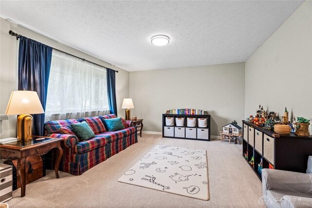 carpeted living room featuring a textured ceiling and baseboards