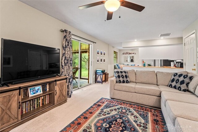 living room with carpet floors and ceiling fan
