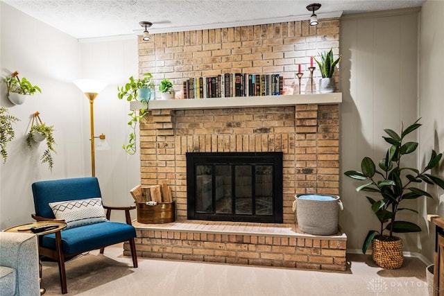 sitting room with carpet floors, a textured ceiling, and a fireplace