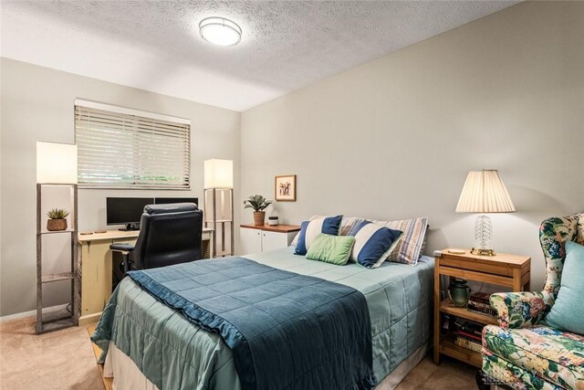 bedroom with carpet floors, baseboards, a desk, and a textured ceiling
