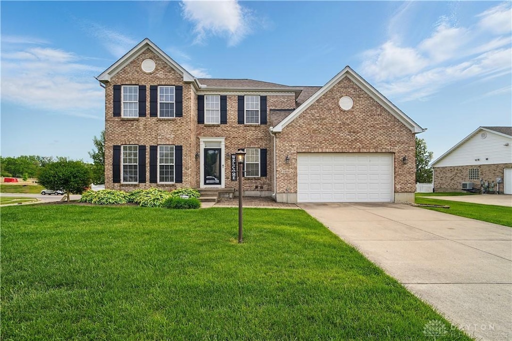 1296 Heather Renee Ct, Miamisburg, OH 45342 - colonial home with a front yard, driveway, a garage, and brick siding