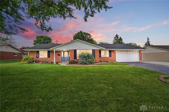 2247 Brookpark Dr, Dayton, OH 45440 - single story home with an attached garage, asphalt driveway, a front yard, and brick siding
