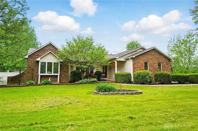 view of front of home featuring brick siding and a front yard
