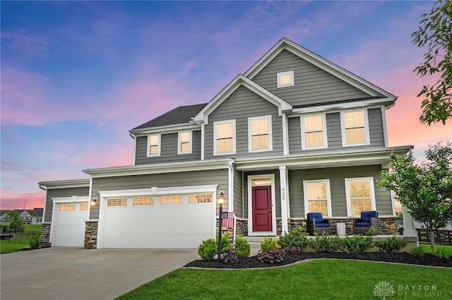 920 Acorn Dr, Sugarcreek Township, OH 45440 - view of front of house with covered porch, stone siding, concrete driveway, and a lawn