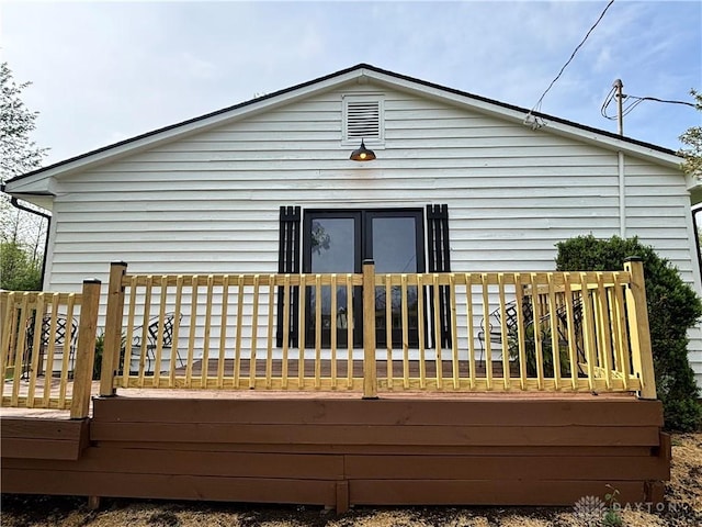 back of house with a deck