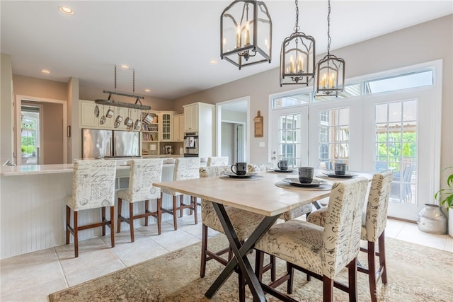 dining room featuring a chandelier, plenty of natural light, light tile patterned floors, and recessed lighting