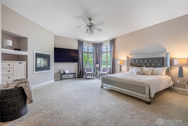 carpeted bedroom featuring baseboards and a ceiling fan