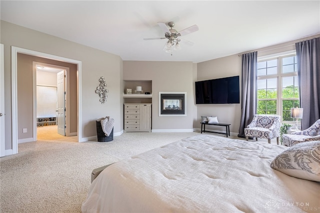 bedroom featuring carpet flooring, baseboards, ceiling fan, and connected bathroom