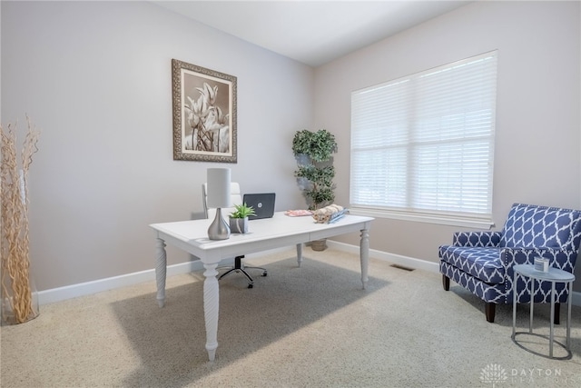 carpeted office space featuring baseboards