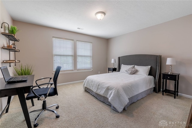 bedroom featuring carpet flooring, baseboards, and an office area